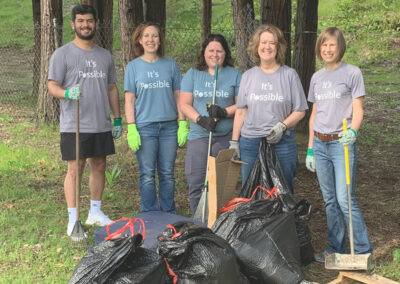 Johnson Bixby team members working outdoors to improve the community
