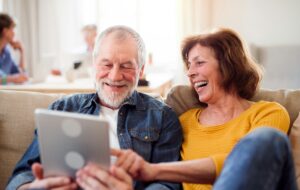 Happy couple looks at tablet screen